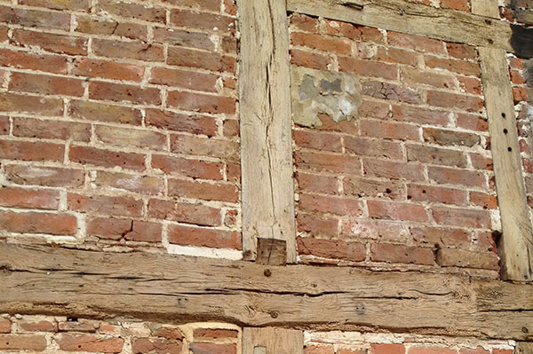 timber-frame-records-brick-wall